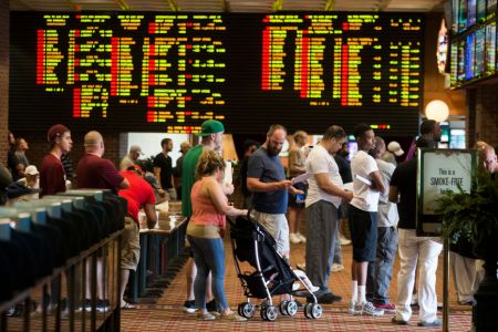 Patrons wait in long lines inside Vegas Sports Betting at Delaware Park Racetrack in Stanton, DE on June 10, 2018. In May, the US Supreme Court overturned a 1992 federal law that banned commercial sports betting in most states. Delaware became the first state to take advantage of the ruling, beginning June 5. (Photo by Stan Grossfeld/The Boston Globe via Getty Images)