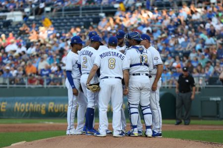 Kansas City Royals shortstop Alcides Escobar (2), third baseman Mike Moustakas (8), catcher Salvador Perez (13) and others huddle around struggling starting pitcher Jason Hammel (39) in the second inning of an MLB game between the Boston Red Sox and Kansas City Royals on July 6, 2018 at Kauffman Stadium in Kansas City, MO.  (Photo by Scott Winters/Icon Sportswire via Getty Images)