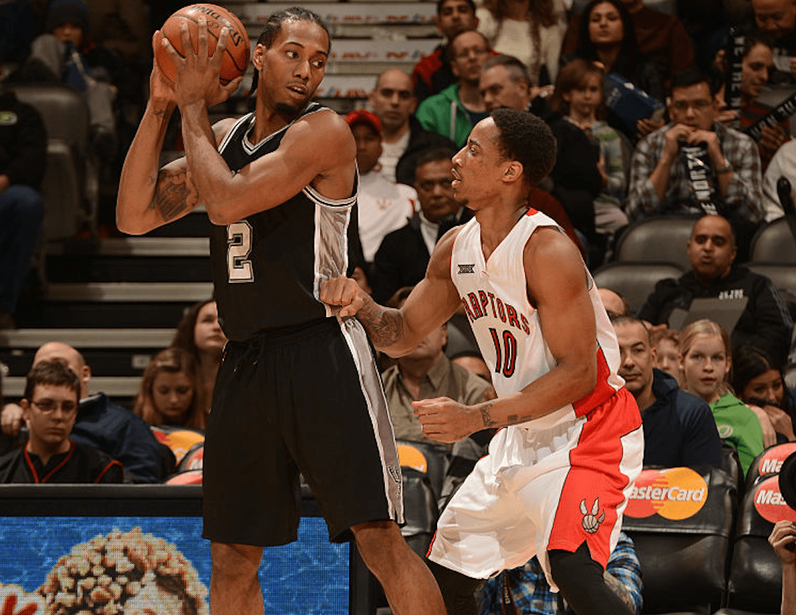 Kawhi Leonard #2 of the San Antonio Spurs handles the ball against DeMar DeRozan #10 of the Toronto Raptors on February 8, 2015 at the Air Canada Centre in Toronto, Ontario, Canada. (Photo by Ron Turenne/NBAE via Getty Images)