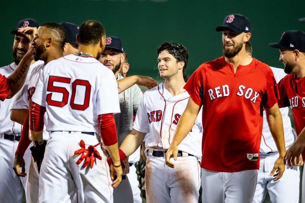 BOSTON, MA - AUGUST 5: Andrew Benintendi #16 of the Boston Red Sox reacts with teammates after hitting the game winning walk off single during the tenth inning of a game against the New York Yankees on August 5, 2018 at Fenway Park in Boston, Massachusetts. (Photo by Billie Weiss/Boston Red Sox/Getty Images)