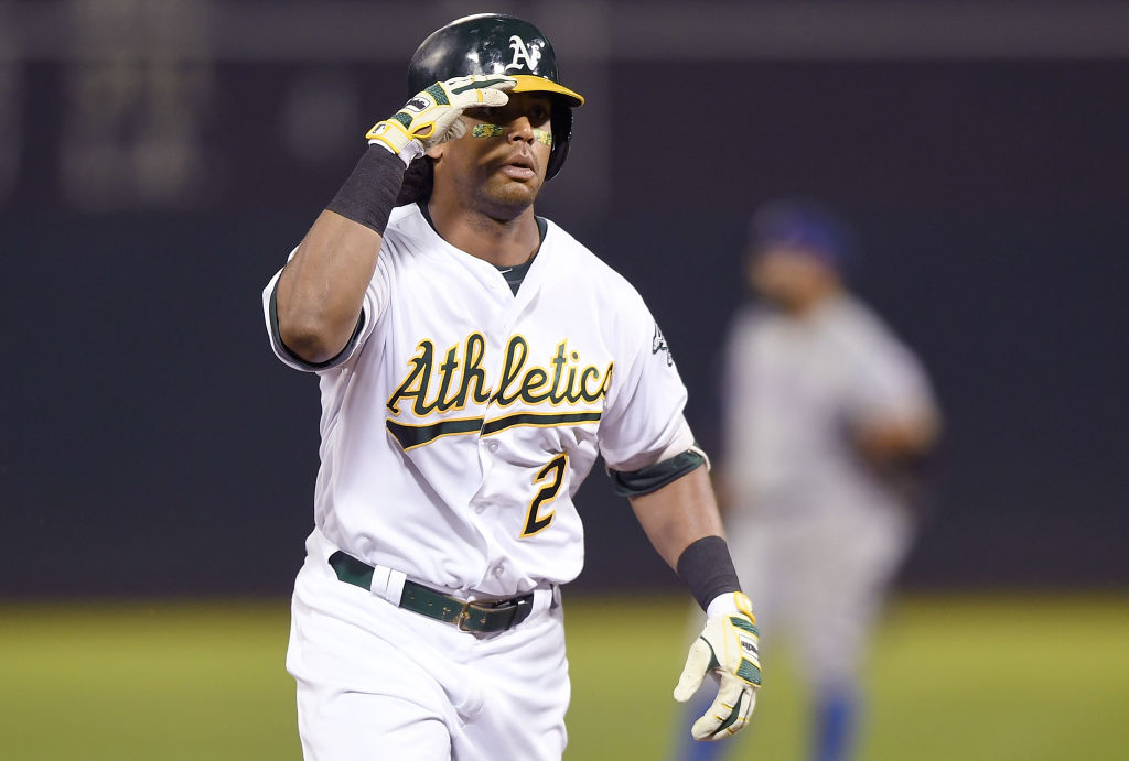 OAKLAND, CA - AUGUST 20:  Khris Davis #2 of the Oakland Athletics salutes his teammates while trotting around the bases after hitting a solo home run against the Texas Rangers in the bottom of the third inning at Oakland Alameda Coliseum on August 20, 2018 in Oakland, California.  (Photo by Thearon W. Henderson/Getty Images)