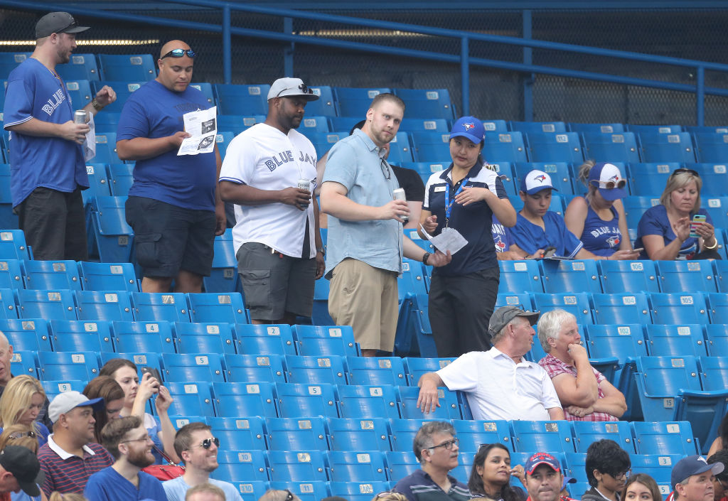 TORONTO, ON - AUGUST 7: Fans of the Toronto Blue Jays line up in the aisle as an usher directs them to their seats during MLB game action against the Boston Red Sox at Rogers Centre on August 7, 2018 in Toronto, Canada. (Photo by Tom Szczerbowski/Getty Images)