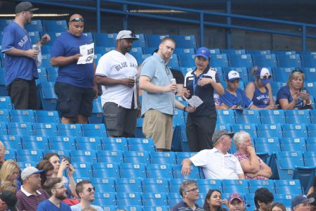 TORONTO, ON - AUGUST 7: Fans of the Toronto Blue Jays line up in the aisle as an usher directs them to their seats during MLB game action against the Boston Red Sox at Rogers Centre on August 7, 2018 in Toronto, Canada. (Photo by Tom Szczerbowski/Getty Images)