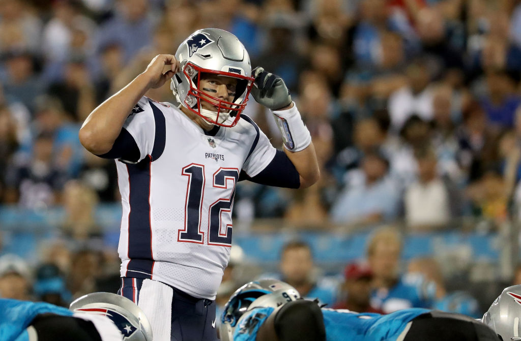 CHARLOTTE, NC - AUGUST 24:  Tom Brady #12 of the New England Patriots makes a call at the line against the Carolina Panthers in the second quarter during their game at Bank of America Stadium on August 24, 2018 in Charlotte, North Carolina.  (Photo by Streeter Lecka/Getty Images)