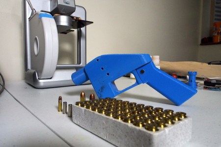 A Liberator pistol appears on July 11, 2013 next to the 3D printer on which its components were made. The single-shot handgun is the first firearm that can be made entirely with plastic components forged with a 3D printer and computer-aided design (CAD) files downloaded from the Internet. (Robert MacPherson/AFP/Getty Images)