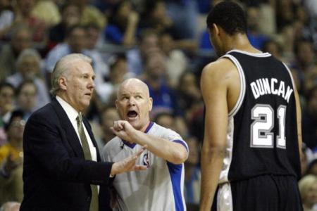 AUBURN HILLS, UNITED STATES:  Tim Duncan (R) of the San Antonio Spurs tries to talk with offical Joe Crawford (C) as head coach Gregg Popovich (L) listens during their game against the Detroit Pistons during the first half of game three of the NBA Finals 14 June, 2005 at The Palace in Auburn Hill, Michigan. (JEFF HAYNES/AFP/Getty Images)