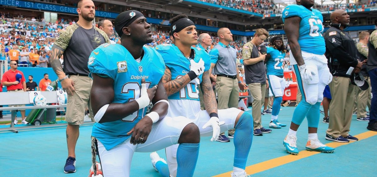 Michael Thomas #31 of the Miami Dolphins and  Kenny Stills #10 of the Miami Dolphins take a knee during the national anthem prior to the game against the New York Jets at the Hard Rock Stadium on November 6, 2016 in Miami Gardens, Florida.  (Photo by Chris Trotman/Getty Images)