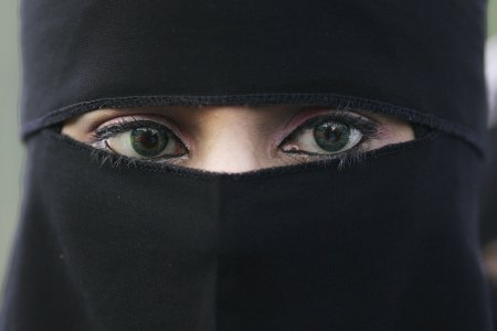 A Muslim woman wearing a niqab veil protests outside Bangor Street Community centre where Leader of the House of Commons Jack Straw is holding one of his weekend surgery appointments where he faced a protest by around 50 Muslim protesters on October 14, 2006, Blackburn, England. (Photo by Christopher Furlong/Getty Images)