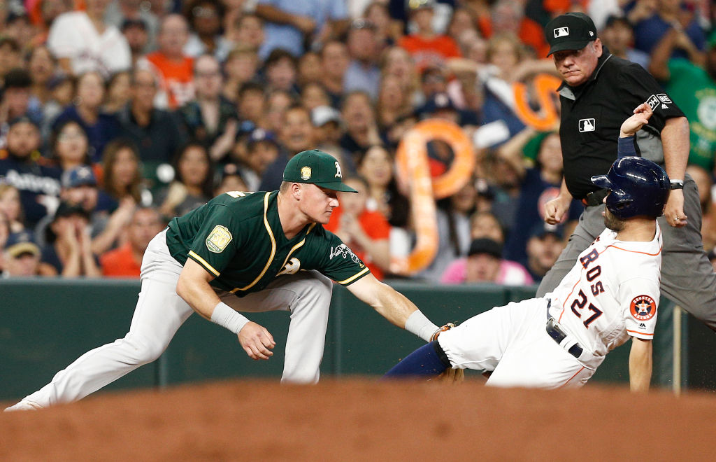 HOUSTON, TX - JULY 09:  Matt Chapman #26 of the Oakland Athletics tags out Jose Altuve #27 of the Houston Astros as he tried to advance on passed ball in the fourth inning at Minute Maid Park on July 9, 2018 in Houston, Texas.  (Photo by Bob Levey/Getty Images)