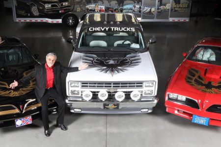 Burt Reynolds with a trio of his personal cars. (Barrett Jackson)
