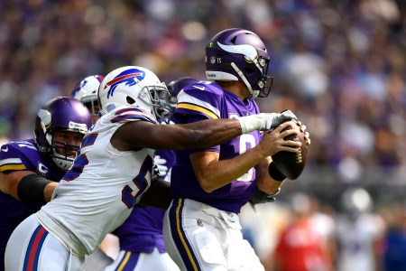 Jerry Hughes #55 of the Buffalo Bills strips the ball out of the hands of Kirk Cousins #8 of the Minnesota Vikings in the first quarter of the game at U.S. Bank Stadium on September 23, 2018 in Minneapolis, Minnesota. The Bills went on to beat the Vikings 27-6, marking the biggest NFL upset in 23 years. (Photo by Hannah Foslien/Getty Images)