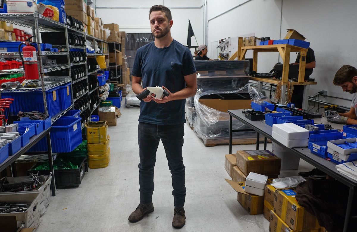 Cody Wilson holds a 3D printed gun in his factory in Austin, Texas on August 1, 2018. Wilson was recently charged with sexual assault of a minor.  (Photo by KELLY WEST/AFP/Getty Images)