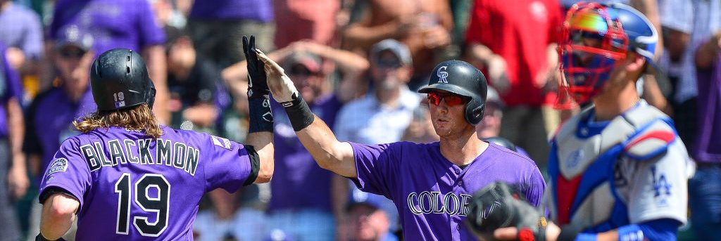 DENVER, CO - AUGUST 12: Charlie Blackmon #19 and DJ LeMahieu #9 of the Colorado Rockies celebrate after Blackmon hit a solo homerun in the sixth inning of a game against the Los Angeles Dodgers at Coors Field on August 12, 2018 in Denver, Colorado. (Photo by Dustin Bradford/Getty Images)