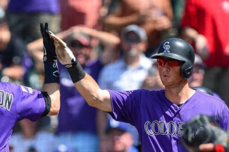 DENVER, CO - AUGUST 12: Charlie Blackmon #19 and DJ LeMahieu #9 of the Colorado Rockies celebrate after Blackmon hit a solo homerun in the sixth inning of a game against the Los Angeles Dodgers at Coors Field on August 12, 2018 in Denver, Colorado. (Photo by Dustin Bradford/Getty Images)