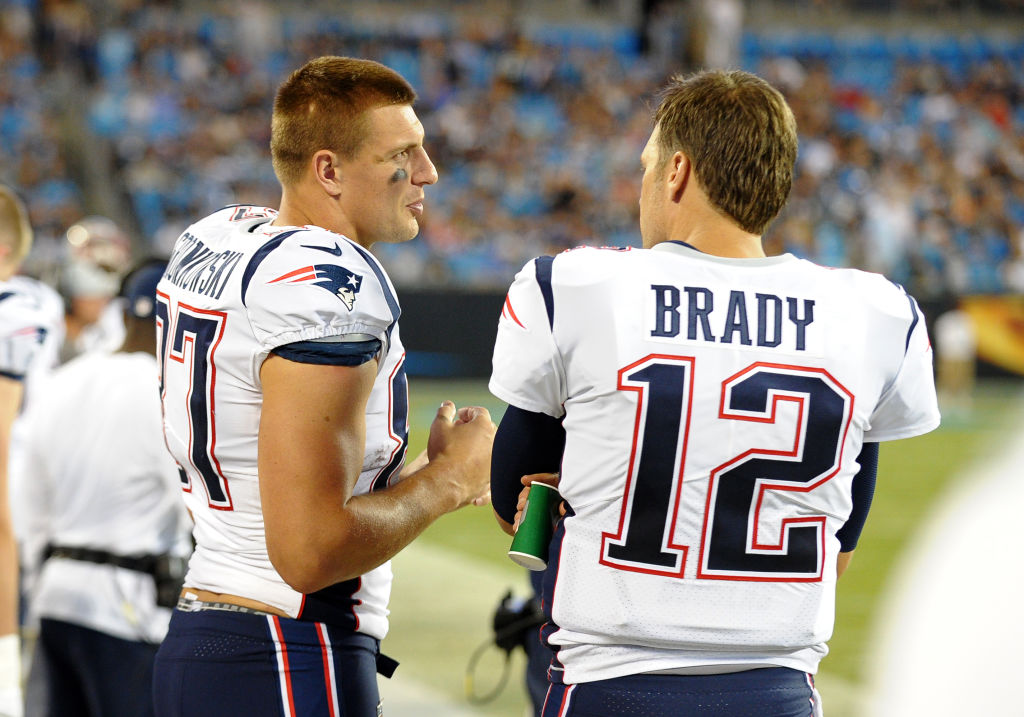CHARLOTTE, NC - AUGUST 24: New England Patriots tight end Rob Gronkowski (87) and New England Patriots quarterback Tom Brady (12) talk on the sideline during a preseason game between the New England Patriots and the Carolina Panthers on August 24, 2018 at Bank of America Stadium in Charlotte,NC. (Photo by Dannie Walls/Icon Sportswire via Getty Images)