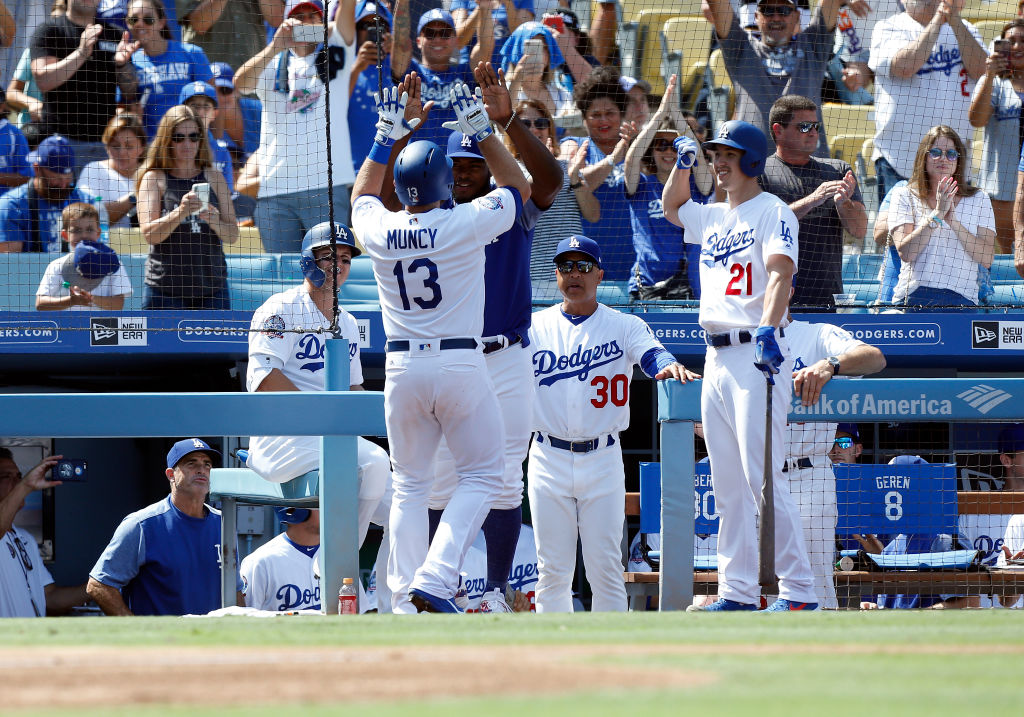 Los Angeles Dodgers infield Max Muncy (13) gets congratulated by Los Angeles Dodgers right fielder Yasiel Puig (66), manager Dave Roberts ( 30 ), and Los Angeles Dodgers pitcher Walker Buehler (21) after Muncy hit a solo home run during the game against the Arizona Diamondbacks on September 02, 2018, at Dodger Stadium in Los Angeles, CA. (Photo by Adam Davis/Icon Sportswire via Getty Images)