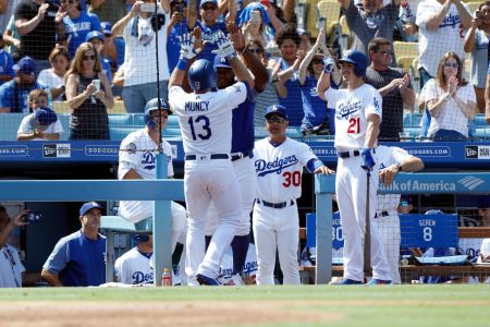 Los Angeles Dodgers infield Max Muncy (13) gets congratulated by Los Angeles Dodgers right fielder Yasiel Puig (66), manager Dave Roberts ( 30 ), and Los Angeles Dodgers pitcher Walker Buehler (21) after Muncy hit a solo home run during the game against the Arizona Diamondbacks on September 02, 2018, at Dodger Stadium in Los Angeles, CA. (Photo by Adam Davis/Icon Sportswire via Getty Images)