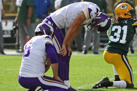 GREEN BAY, WI - SEPTEMBER 16: Daniel Carlson #7 of the Minnesota Vikings (R) reacts after missing a potential game-winning field goal in overtime against the Green Bay Packers  at Lambeau Field on September 16, 2018 in Green Bay, Wisconsin. The Vikings and the Packers tied 29-29 after overtime. (Photo by Jonathan Daniel/Getty Images)