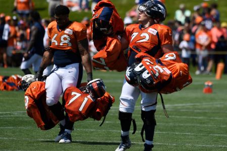 ENGLEWOOD, CO - AUGUST 02: Denver Broncos rookie offensive tackle Elijah Wilkinson #68 and rookie offensive tackle Garett Bolles #72 pay their dues by carrying veteran's pads and helmets into the locker room after practice at Dove Valley August 02, 2017. (Photo by Andy Cross/The Denver Post via Getty Images)
