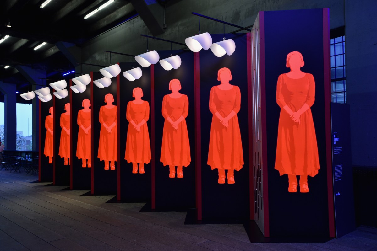 A view of an art installation, designed by Paula Scher and Abbott Miller, and book giveaway celebrating Hulu's 'The Handmaid's Tale' on April 26, 2017 in New York City. The company Yandy recently apologized and took down from its online store a widely-criticized sexualized version of the outfit. (Photo by Bryan Bedder/Getty Images for Hulu)