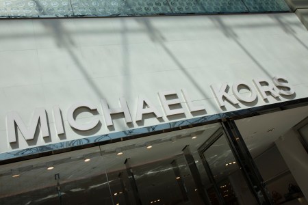 Sign for the luxury clothing brand Michael Kors in Birmingham, United Kingdom. Michael Kors is reportedly close to acquiring Versace. (photo by Mike Kemp/In PIctures via Getty Images)