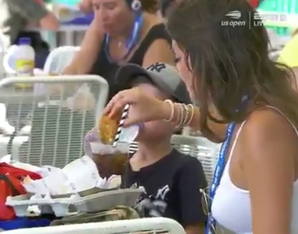 A woman dips a chicken finger in soda at the US Open. (ESPN/Twitter)