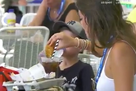 A woman dips a chicken finger in soda at the US Open. (ESPN/Twitter)