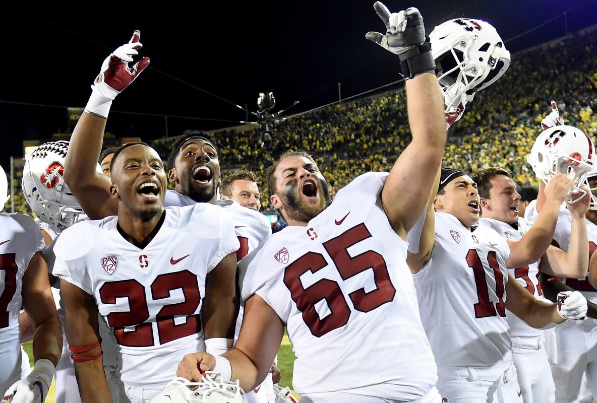 Stanford Cornerback Obi Eboh (22) and center Brian Chaffin (65) celebrate after defeating Oregon in overtime 38-31. (Photo by Steve Dykes/Getty Images)