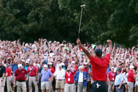 Tiger Woods of the United States celebrates making a par on the 18th green to win the TOUR Championship at East Lake Golf Club on September 23, 2018 in Atlanta, Georgia. With the victory, Woods secured his 80th PGA tour victory.  (Photo by Tim Bradbury/Getty Images)