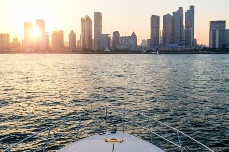 View of cityscape from a yacht, Qingdao, Shandong, China. The coming SolarImpact Yacht will promote an electric future for the yacht industry.  	(Photo by Sino images/Getty Images)