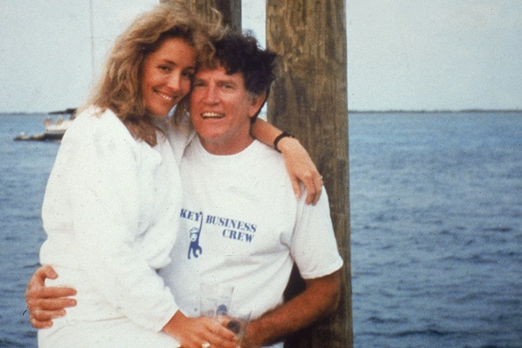 American politician Gary Hart sits on a dock with Donna Rice on his lap, 1987. (Photo by National Enquirer/Getty Images)