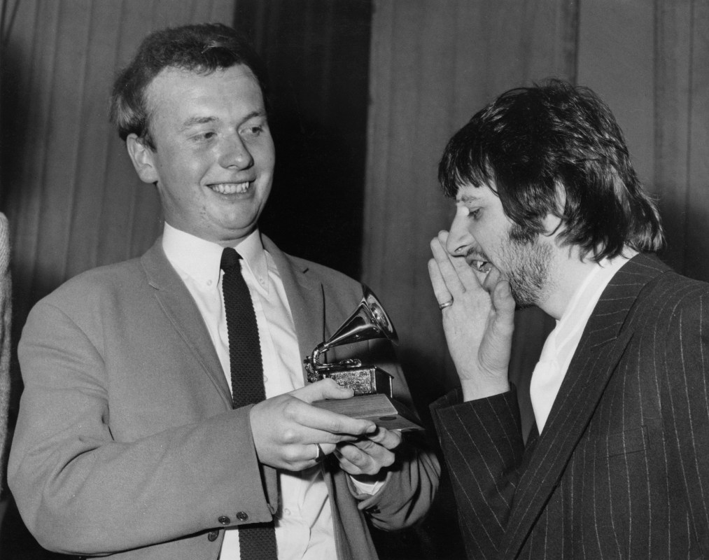 Drummer Ringo Starr of English congratulates EMI recording studio audio engineer Geoff Emerick (left) on his Grammy Award at the EMI studios in London, 7th March 1968. Emerick recently passed away at the age of 72. (Photo by Monti Spry/Central Press/Hulton Archive/Getty Images)