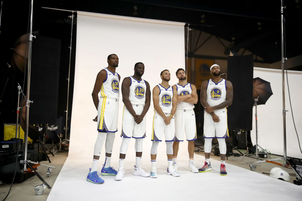 OAKLAND, CA - SEPTEMBER 24:  (L-R) Kevin Durant #35, Draymond Green #23, Stephen Curry #30, Klay Thompson #11, and DeMarcus Cousins #0 of the Golden State Warriors pose for a group picture during the Golden State Warriors media day on September 24, 2018 in Oakland, California.  (Photo by Ezra Shaw/Getty Images)