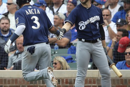 Orlando Arcia #3 of the Milwaukee Brewers is congratulated by Ryan Braun #8 after scoring a run in the 3rd inning against the Chicago Cubs during the National League Tiebreaker Game at Wrigley Field on October 1, 2018 in Chicago, Illinois. (Photo by Jonathan Daniel/Getty Images)