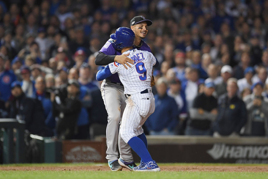 CHICAGO, IL - OCTOBER 02:  Javier Baez #9 of the Chicago Cubs hugs Nolan Arenado #28 of the Colorado Rockies in the eleventh inning during the National League Wild Card Game at Wrigley Field on October 2, 2018 in Chicago, Illinois.  (Photo by Stacy Revere/Getty Images)