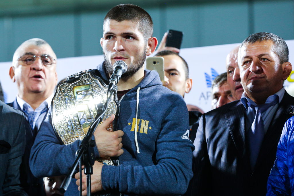 UFC lightweight champion Khabib Nurmagomedov (C) with father and coach Abdulmanap Nurmagomedov (R) address supporters at Anzhi Arena Stadium after defending his UFC title by defeating Irish MMA fighter Conor McGregor at the UFC 229 tournament. Musa Salgereyev/TASS (Photo by Musa SalgereyevTASS via Getty Images)