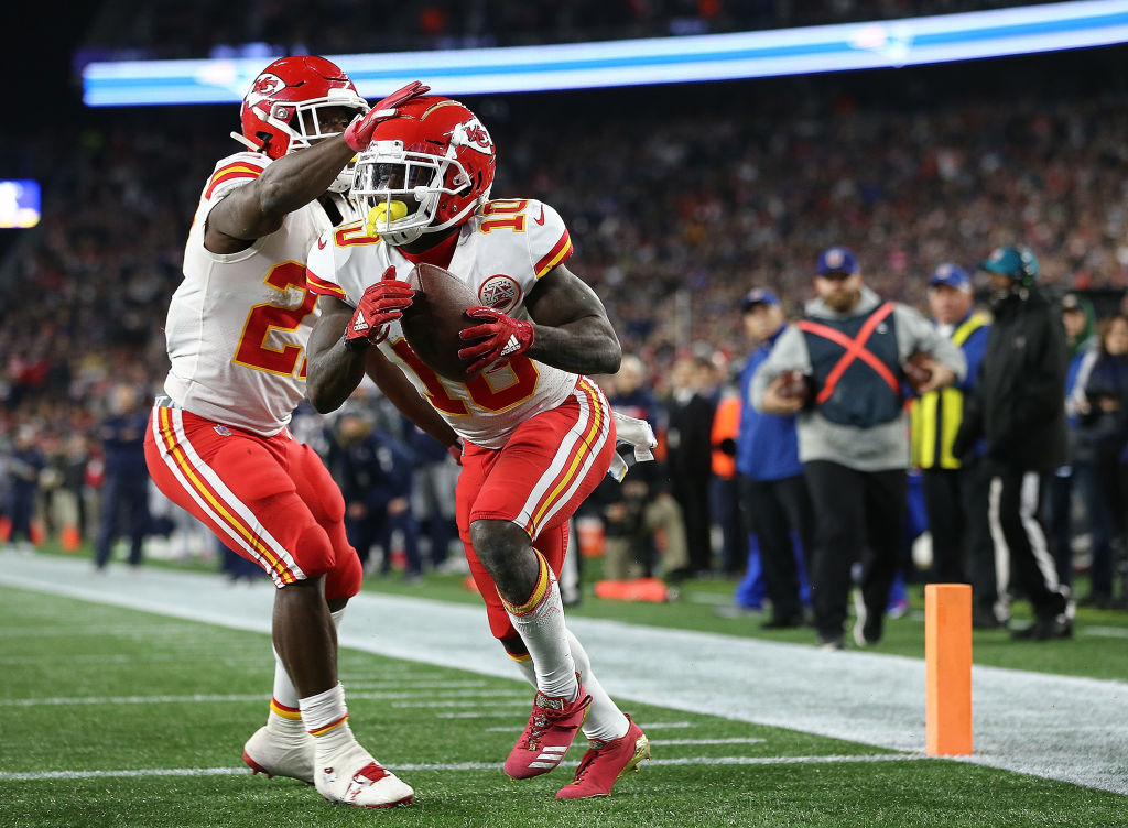 Tyreek Hill #10 of the Kansas City Chiefs celebrates a touchdown pass with Kareem Hunt #27 of the Kansas City Chiefs against the  New England Patriots in the fourth quarter at Gillette Stadium on October 14, 2018 in Foxborough, Massachusetts. (Photo by Jim Rogash/Getty Images)