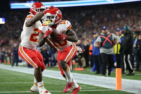 Tyreek Hill #10 of the Kansas City Chiefs celebrates a touchdown pass with Kareem Hunt #27 of the Kansas City Chiefs against the  New England Patriots in the fourth quarter at Gillette Stadium on October 14, 2018 in Foxborough, Massachusetts. (Photo by Jim Rogash/Getty Images)