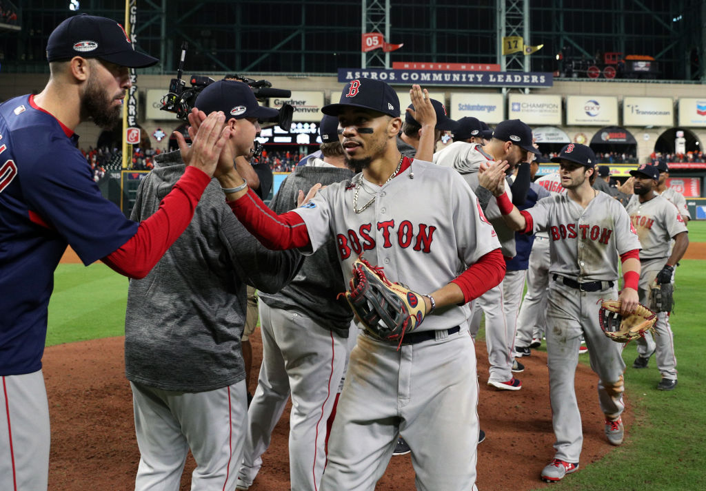 HOUSTON, TX - OCTOBER 17: Mookie Betts #50 of the Boston Red Sox celebrates with teammates after Red Sox defeated the Houston Astros in Game 4 of the ALCS at Minute Maid Park on Wednesday, October 17, 2018 in Houston, Texas. (Photo by Loren Elliott/MLB Photos via Getty Images)