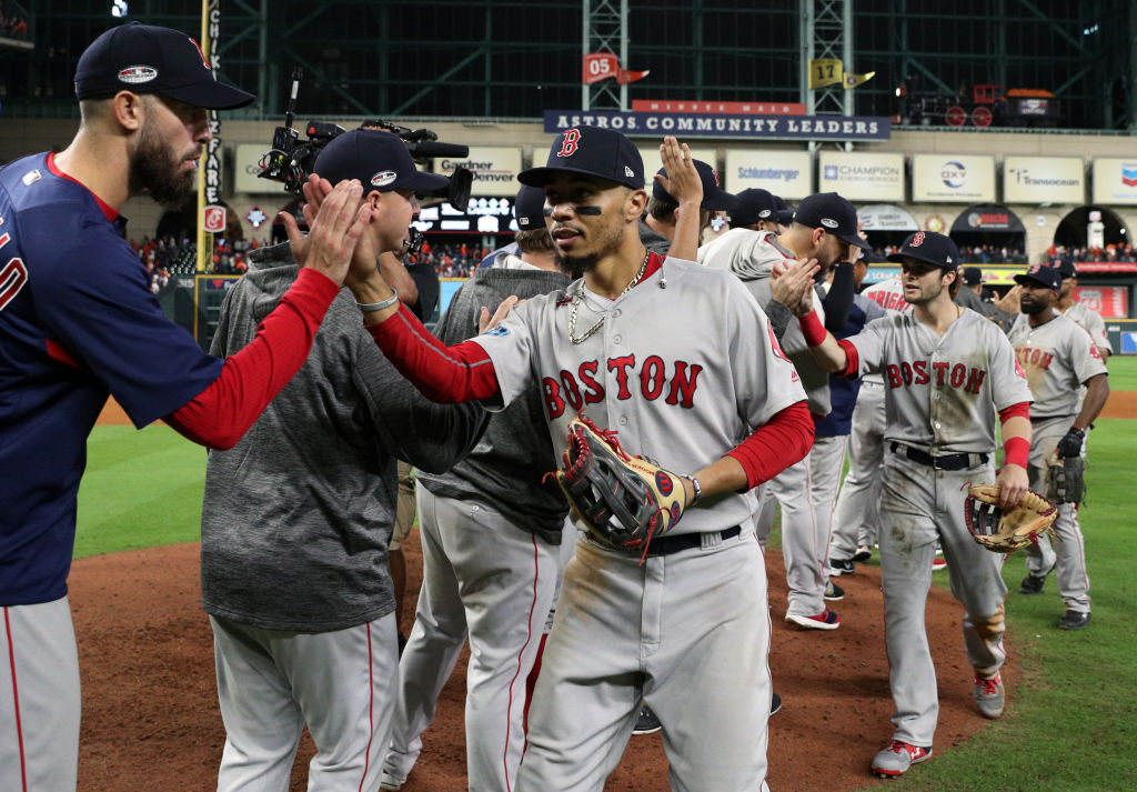 HOUSTON, TX - OCTOBER 17:  Mookie Betts #50 of the Boston Red Sox celebrates with teammates after Red Sox defeated the Houston Astros in Game 4 of the ALCS at Minute Maid Park on Wednesday, October 17, 2018 in Houston, Texas. (Photo by Loren Elliott/MLB Photos via Getty Images)