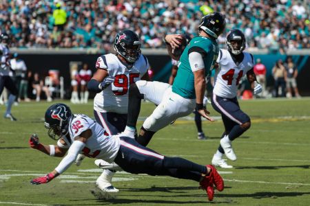 Blake Bortles #5 of the Jacksonville Jaguars is brought down by members of the Houston Texans defense during the second half at TIAA Bank Field on October 21, 2018 in Jacksonville, Florida.  (Photo by Scott Halleran/Getty Images)