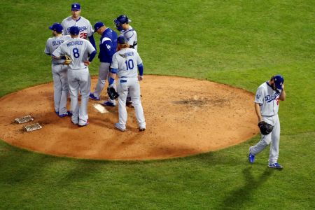BOSTON, MA - OCTOBER 23:  Clayton Kershaw #22 of the Los Angeles Dodgers walks back to the dugout during a pitching change during Game 1 of the 2018 World Series against the Boston Red Sox at Fenway Park on Tuesday, October 23, 2018 in Boston, Massachusetts. (Photo by Adam Glanzman/MLB Photos via Getty Images)