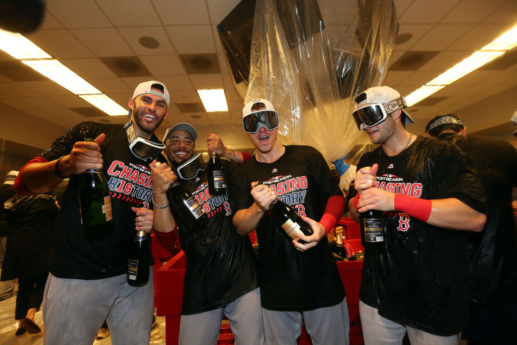 NEW YORK, NEW YORK - OCTOBER 09:  J.D. Martinez #28, Mookie Betts #50, Brock Holt #12 and Andrew Benintendi #16 of the Boston Red Sox celebrate in the locker room with his team after defeating the New York Yankees to win Game Four American League Division Series by a score of 4-3 at Yankee Stadium on October 09, 2018 in the Bronx borough of New York City. (Photo by Elsa/Getty Images)