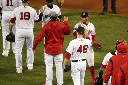 BOSTON - OCTOBER 24: Boston Red Sox player Mookie Betts holds up two fingers with teammates as the Red Sox celebrate the 4-2 win over the Dodgers. (Photo by Stan Grossfeld/The Boston Globe via Getty Images)