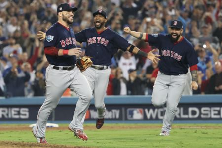 Steve Pearce #25, Eduardo Nunez #36, and Sandy Leon #3 of the Boston Red Sox celebrate after the Boston Red Sox defeat the Los Angeles Dodgers in Game 5 of the 2018 World Series at Dodger Stadium on Sunday, October 28, 2018 in Los Angeles, California. (Photo by Rob Tringali/MLB Photos via Getty Images)