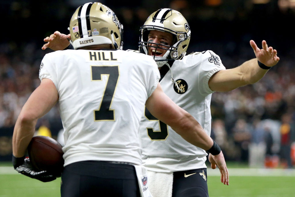 NEW ORLEANS, LA - OCTOBER 08: Taysom Hill #7 of the New Orleans Saints reats with Drew Brees #9 of the New Orleans Saints after scoring a touchdown during the second half against the Washington Redskins at the Mercedes-Benz Superdome on October 8, 2018 in New Orleans, Louisiana. (Photo by Sean Gardner/Getty Images)