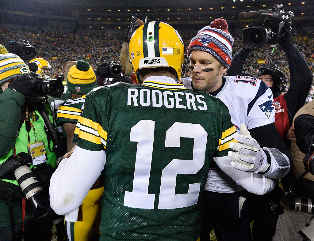 Tom Brady #12 of the New England Patriots (R) congratulates fellow quarterback Aaron Rodgers #12 of the Green Bay Packers after their game at Lambeau Field on November 30, 2014 in Green Bay, Wisconsin.  (Photo by Brian D. Kersey/Getty Images)