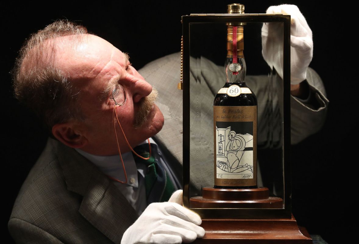 Whisky expert Charles MacLean with the world's rarest and most valuable whisky - a bottle of The Macallan Valerio Adami 60 year-old 1926. The bottle sold at auction in Scotland for $1.1 million. (Photo by Andrew Milligan/PA Images via Getty Images)