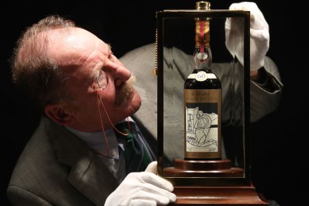Whisky expert Charles MacLean with the world's rarest and most valuable whisky - a bottle of The Macallan Valerio Adami 60 year-old 1926. The bottle sold at auction in Scotland for $1.1 million. (Photo by Andrew Milligan/PA Images via Getty Images)