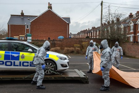 Military personnel wearing protective suits remove a police car and other vehicles from a public park park as they continue investigations into the poisoning of Sergei Skripal on March 11, 2018 in Salisbury, England. One of the men accused of the poisoning has been revealed to be Alexander Mishkin, reportedly a trained Russian military doctor. (Photo by Chris J Ratcliffe/Getty Images)